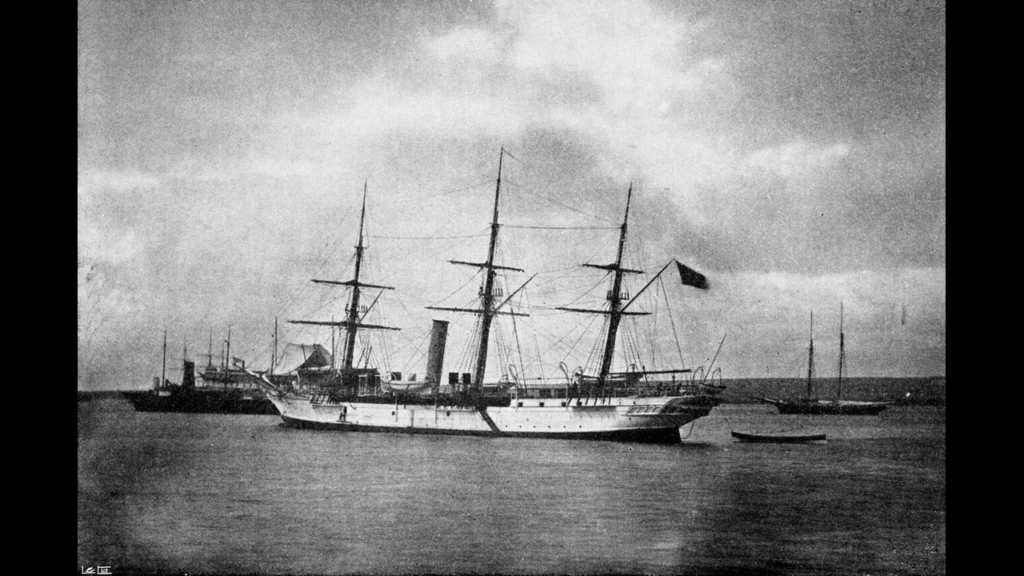 A 19th-century naval vessel with three masts and a steam funnel anchored at sea